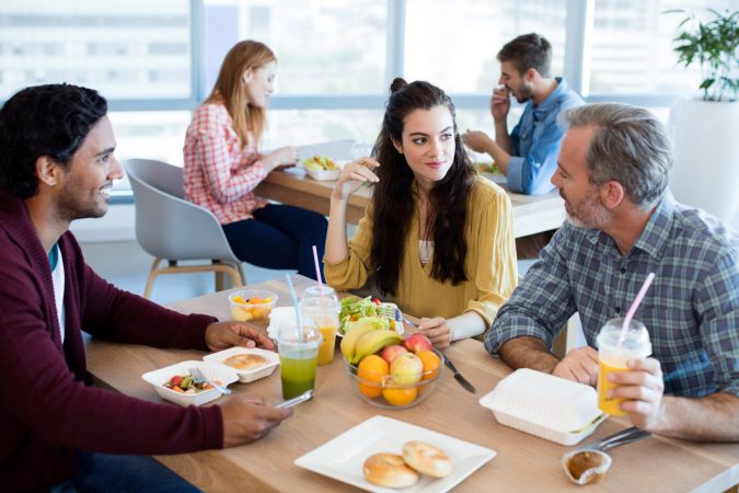 creative-business-team-discussing-while-having-mea-2023-11-27-04-59-36-utc