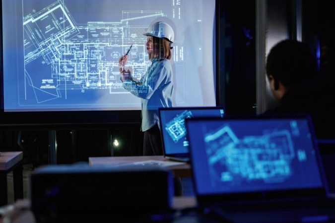 in-white-hard-hat-female-architect-is-showing-con-2025-03-18-20-05-56-utc