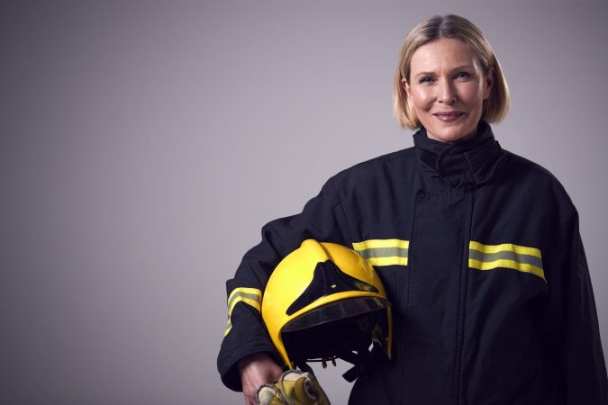 studio-portrait-of-smiling-mature-female-firefight-2024-10-22-07-02-43-utc