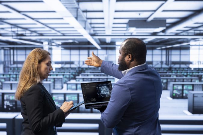 team-of-technicians-in-data-center-using-laptop-to-2025-02-20-02-30-30-utc